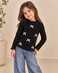 Hermosa blusa para niña confeccionada en tela acanalada, con delicados moñitos decorativos que le dan un estilo dulce y elegante. ✨